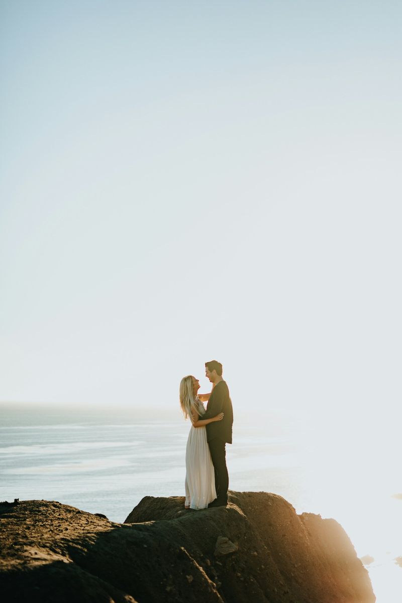 Couple embracing on a clifftop above the sea